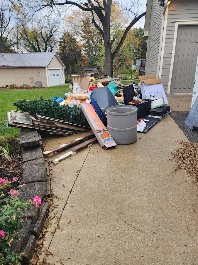 Dumpster being loaded with debris for Estate Cleanout Dumpster Rental in Saco